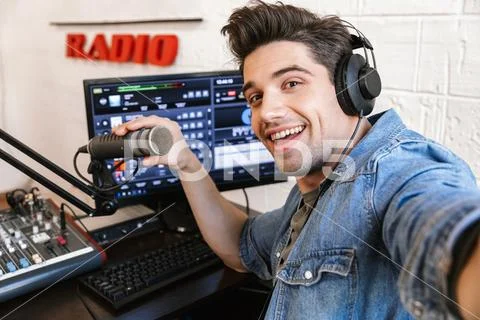 Handsome happy young male radio host broadcasting Stock Photos
