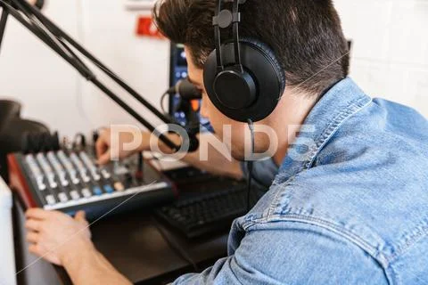 Handsome happy young male radio host broadcasting Stock Photos