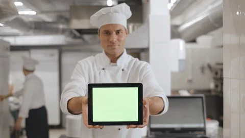 Handsome head chef with digital tablet in industrial kitchen Stock Footage 125049644
