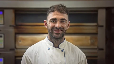 Handsome head chef portrait at bakery kitchen. Baker look at camera and smile. 動画素材 271222032