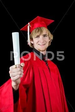 Handsome high school graduate wearing red cap and gown Stock Photos