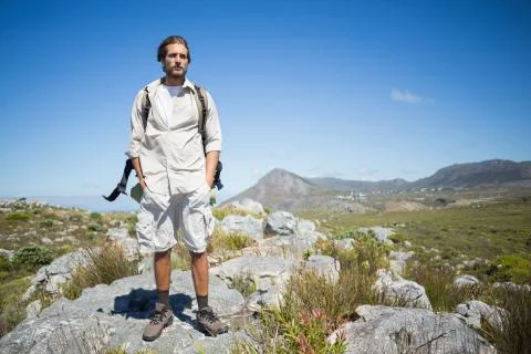 Handsome hiker standing at the summit Stock Photos