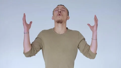 Handsome hipster guy tries to keep tranquility, to be quiet, to calm himself. Stock Footage 141426673