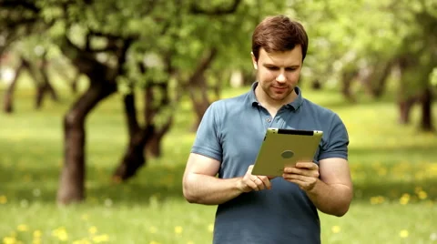 Handsome hipster man using his tablet pc on a sunny day Video stock 63195980