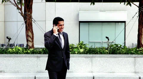 Handsome hispanic businessman talking at phone Stock Footage