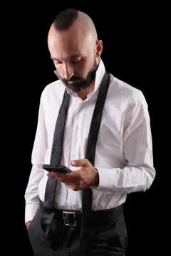 Handsome hispanic man checking his phone while dressing Stock Photos