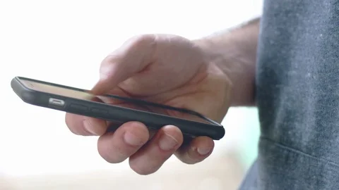 Handsome hispanic man scrolling through social media page on smartphone Stock Footage 84479531