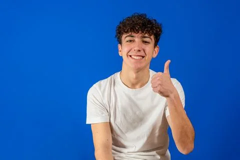 Handsome hispanic model man over isolated background doing happy thumbs up ge Stock Photos