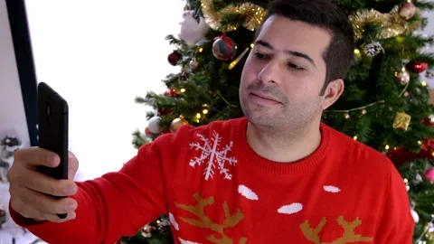 Handsome hispanic young man taking selfies with his smartphone Stock Footage 140843455