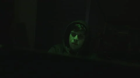 Handsome Hooded Young Computer Hacker or Programmer Working on Computer wit.. Stock Footage 234152101