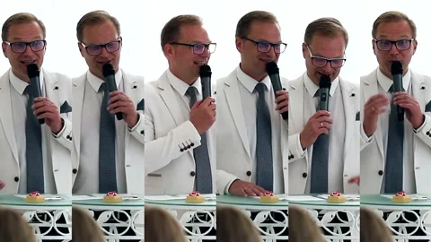 A handsome host leads the wedding ceremony. collage, multiscreen. An artist in a Stock Footage 266413531