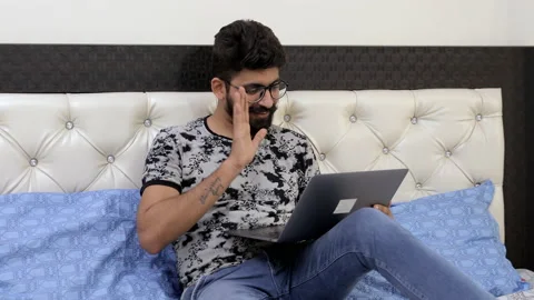 A handsome Indian guy in spectacles busy over a video call - lifestyle concept 스톡 동영상 133223696
