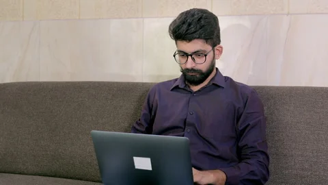 Handsome Indian guy working on his laptop during the Covid-19 pandemic time Stock Footage 157849510
