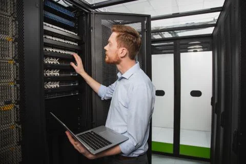 Handsome IT technician performing test Stock Photos