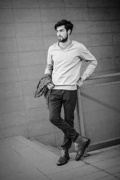 Handsome Italian dark-haired guy on the roof of a tall building Stock-Fotos