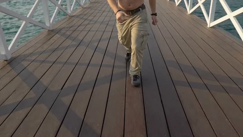 Handsome Lifeguard Dramatic Slow Motion Running Taking Off Sunglasses at Beach Stock Footage 126261119