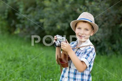 Handsome little boy with retro camera outdoors Stock Photos