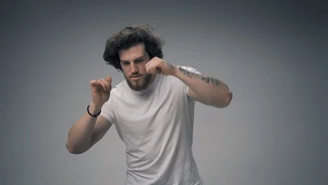 Handsome long haired man dancing raggie in white t shirt Stock Footage 127802064