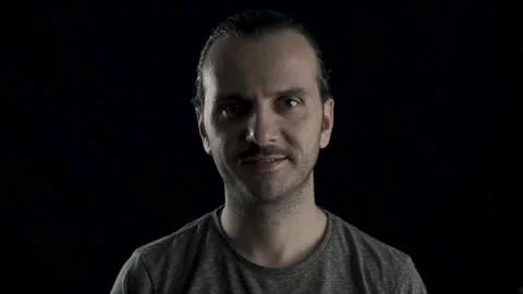 Handsome long haired young man with brace is smiling. He's showing his teeth  Stock Footage 133414852