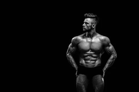 Handsome male model posing at studio in front of a black background Stock Photos