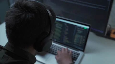 Handsome male software developer programming codes while working behind laptop Stock Footage 153499915