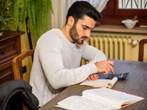 Handsome man accounting at table Stock Photos