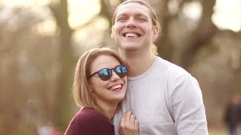 Handsome man and middle-aged woman hugging in a spring park and smiling. He Stock Footage 87125301