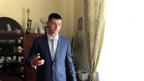 Handsome man in the apartment uses cologne. wedding day Stock Footage 80503218