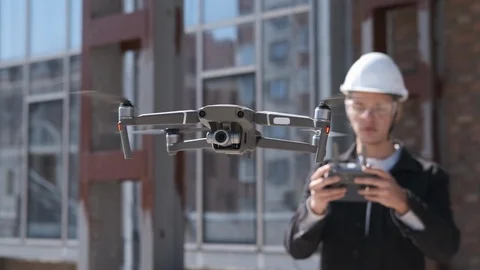 Handsome man architect controlling flying drone for aerial view. Stock Footage 106236093