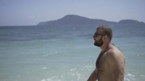 Handsome man is on the beach. Stock Footage 60780403