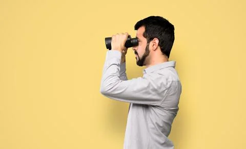 Handsome man with beard  with binoculars. Stock Photos