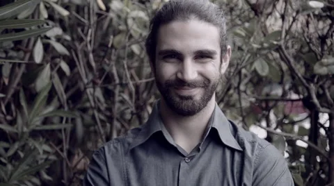 Handsome man with beard looking camera smiling Stock Footage 56062401