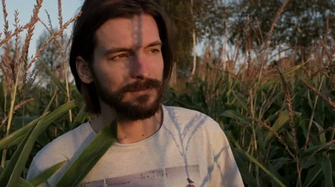 Handsome man with beard with nature landscape in sunset/sunrise. Stockbeeldmateriaal 54235657