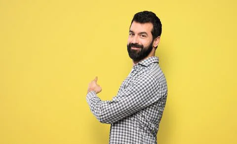 Handsome man with beard pointing back Stock Photos