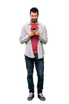 Handsome man with beard sending a message with the mobile Stock Photos