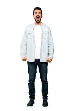 Handsome man with beard shouting to the front with mouth wide open Photos