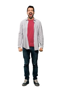 Handsome man with beard shouting to the front with mouth wide open Photos