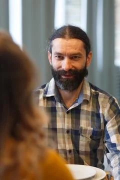 A handsome man with a beard sits and admires his wife Фото