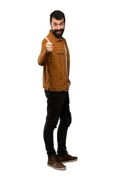 Handsome man with beard with thumbs up because something good has happened Stock Photos
