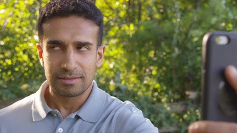 Handsome man being lectured on facetime. - Slow Motion - shot on RED Stock Footage 125161973