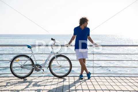 Handsome Man With Bicycle Resting Outdoors