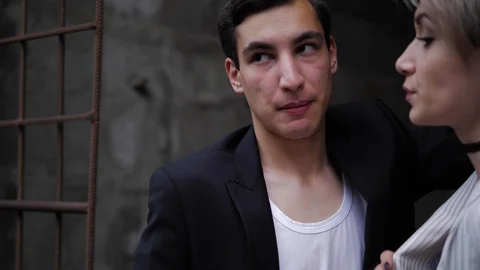 Handsome man in black jacket stands close to lady slow Stock Footage 115253333