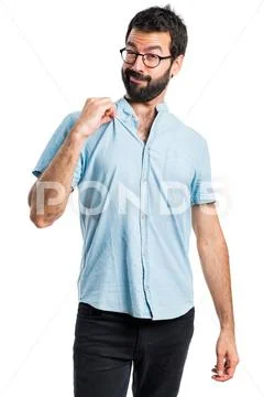 Handsome man with blue glasses proud of himself Stock Photos