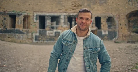 Handsome man in blue jeans jacket and white shirt, stylish hat looking around ri Stock Footage 117417635