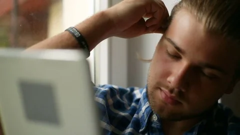 Handsome man browsing internet on tablet and smiling to the camera Stock Footage 75134581