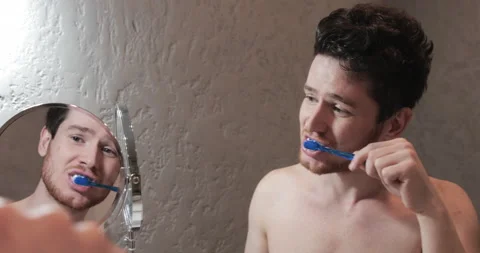 Handsome Man Brush Teeth Looking Face In Front Of Mirror. Sexy Man At Bathroom. Stock Footage 155076430