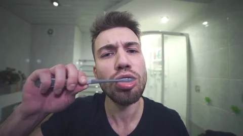 Handsome man brushing his teeth toothy smile slider dolly Stock Footage 71960067
