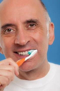Handsome man brushing his teeth Stock Photos