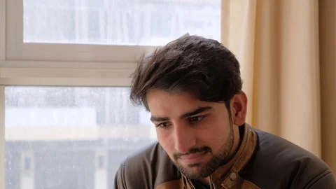 Handsome man busy looking somewhere looks at the camera and smiles  Stock Footage 101286144