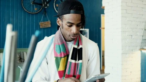 Handsome man in cafe with tablet computer Video stock 75892815